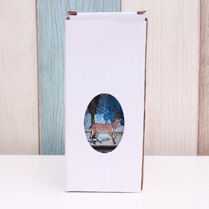 Detailed view of white cardboard packaging box with a deer illustration window
