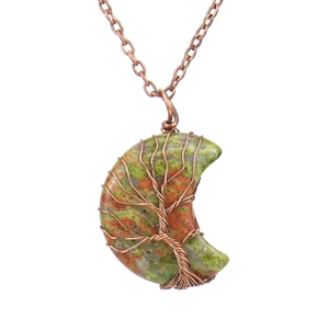 Detail of handmade bronze wire-wrapped unakite crystal moon and tree of life pendant