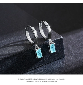 Close-up of S925 silver hoop earrings with rectangular aquamarine gemstone pendants