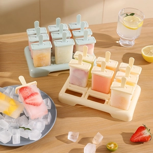 Silicone popsicle mold set with 6 cells and base on a wooden table with fresh summer fruit