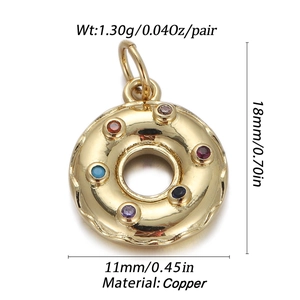Macro detail of golden donut pendant with colorful crystals and copper material