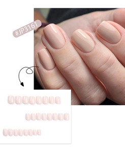 Detail of nude pink short square press-on nails showing natural fit and full set