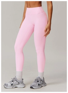 Detail of pink high-waisted yoga pants with seamless texture and athletic styling