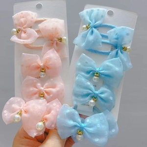 Close-up of pink and blue tulle bow hair clips with pearls on display cards