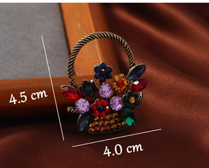 Detailed view of vintage flower basket brooch with colorful rhinestones and size labels