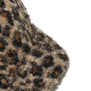 Macro shot of faux shearling fabric with leopard print showing soft texture and thick pile