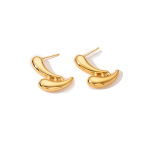 Close-up of golden stainless steel earrings with irregular double-layered curved shapes