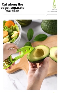 Detailed view of the ergonomic 3-in-1 avocado slicer cutting through fresh fruit peel
