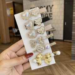 Detailed close-up of a 6-piece elegant hair clip set with pearls and rhinestones