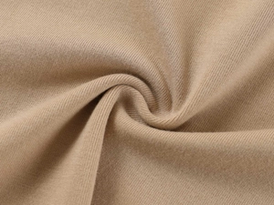 Macro shot of khaki ribbed knit fabric texture showing premium cotton material details