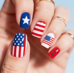 Close-up of patriotic American flag press-on nails with red stripes and blue stars