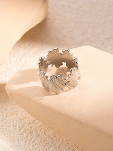 Close-up of a silver titanium steel ring with an intricate butterfly wing design on stone
