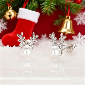 Detail of Christmas reindeer antler pearl earrings with silver metal and white pearl studs
