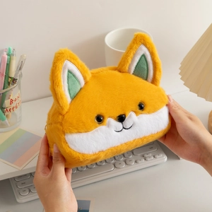Close-up of cute plush fox stationery bag with soft orange fur and zipper detail