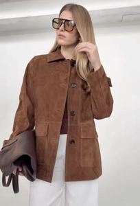 Detail of a brown suede jacket for women with flap pockets and single-breasted design