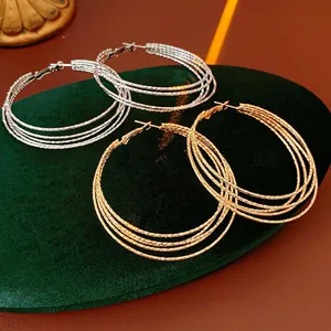Chic multi-layered gold and silver hoop earrings with sparkling textured glitter finish