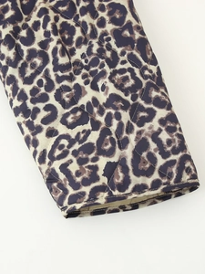 Detail of leopard print quilted jacket showing ribbed cuff and wavy stitching texture