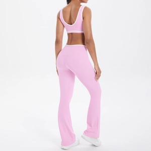 Rear view of pink high-waist flared yoga pants and sports bra set with white piping