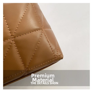 Close-up of brown leather quilted tote bag showing detailed rhombic stitching and texture
