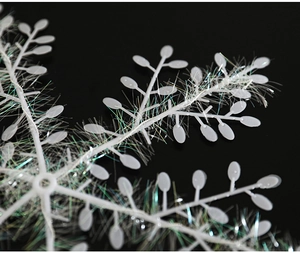 Macro shot of white iridescent wire snowflake ornament with detailed laser silk texture