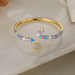Detailed close-up of golden snake bracelet with colorful enamel and sparkling zircons
