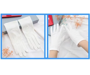 Detail of white cotton sun protection gloves with touchscreen and anti-slip grip design