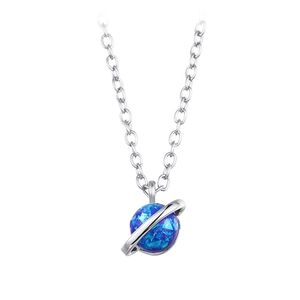 Macro shot of silver-tone opal planet pendant with faceted blue gemstone on a fine chain