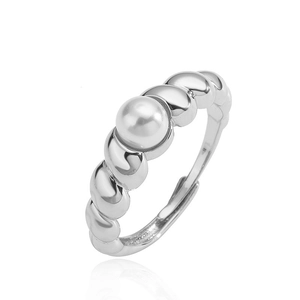 Detailed view of silver croissant ring featuring a lustrous pearl and twisted metal design