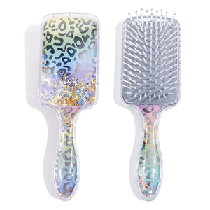 Detail of square cushion hairbrush with glitter butterfly sequins and leopard pattern