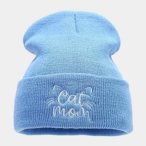 Close-up of Cat Mom embroidery on a sky blue ribbed knit beanie for winter