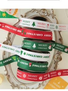 Macro shot of grosgrain Christmas ribbons with Merry Christmas prints on a white frame