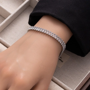 Close-up of rectangular clear zircon tennis bracelet on wrist with elegant silver finish