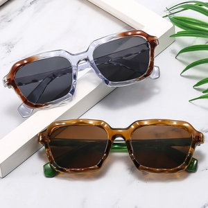 Retro square frame sunglasses in tortoiseshell and purple on white marble background
