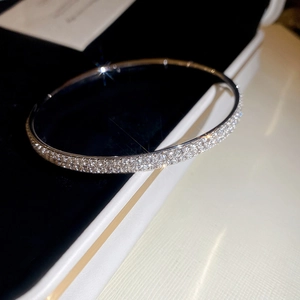 Macro shot of double-row pavé set cubic zirconia on silver-tone elegant metal bracelet