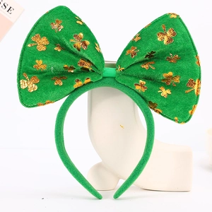 Detail of green velvet Saint Patrick's Day headband with gold clover print and big bow