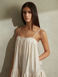 Chic backless cream white pleated midi dress with spaghetti straps and tiered ruffle hem