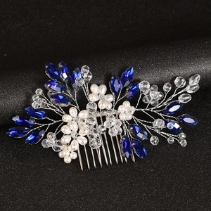 Detail of silver wire bridal hair comb with blue crystals and white pearls