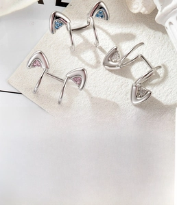 Detailed view of titanium steel cat ear clips with blue, pink, and white cubic zirconia