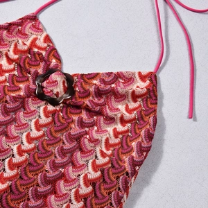 Detail of colorful ripple knit texture with a flower-shaped resin buckle on the strap