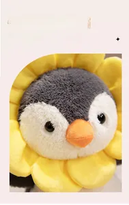 Close-up of plush penguin toy with sunflower petals showing soft fleece texture