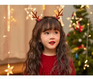 Close-up of a festive Christmas headband with reindeer antlers, pine cones and small mushrooms