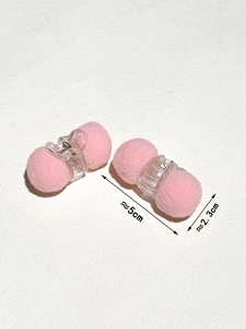 Detail view of 5cm pink plush hair clip showing soft pom-pom texture and spring dimensions