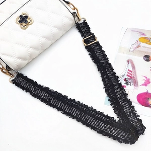 Detail of 3cm black woven fabric strap with texture and metal buckles for small bags