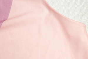 Close-up of breathable pink and purple gradient mesh fabric texture on this stylish outfit