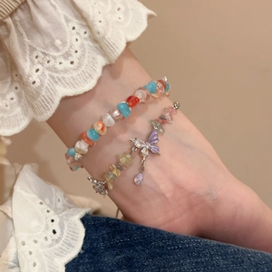 Close-up of a double-layered crystal bead bracelet set with a purple zircon butterfly pendant