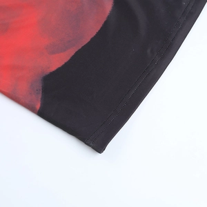 Detail of red and black gradient print with double-needle stitching on stretch fabric