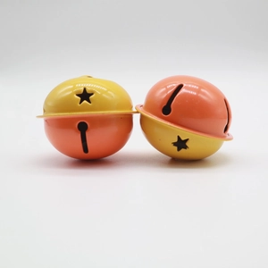 Detail of 4cm dual-tone metal bells with star and keyhole cutouts in yellow and orange