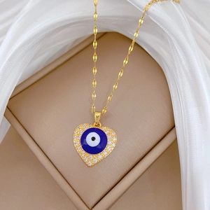 Luxurious gold heart necklace with blue evil eye and sparkling crystals in a gift box