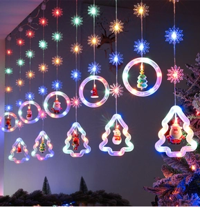 Close-up of LED Christmas curtain lights with snowflake pendants and holiday figurines