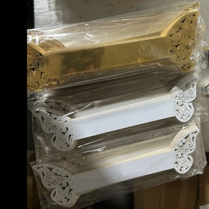 Bulk packs of laser-cut butterfly heart napkin rings in gold and white paper